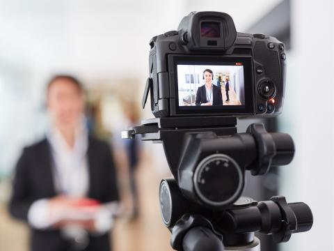 A camera recording video footage of a person