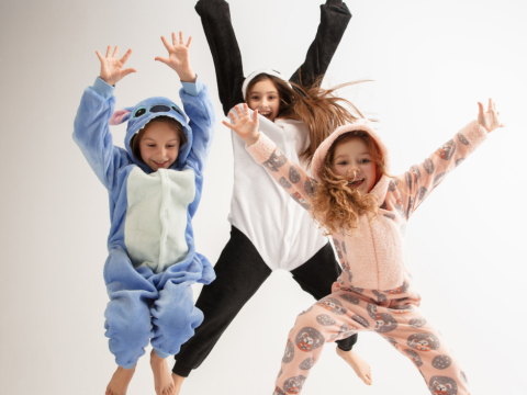 Three kids in PJs jumping