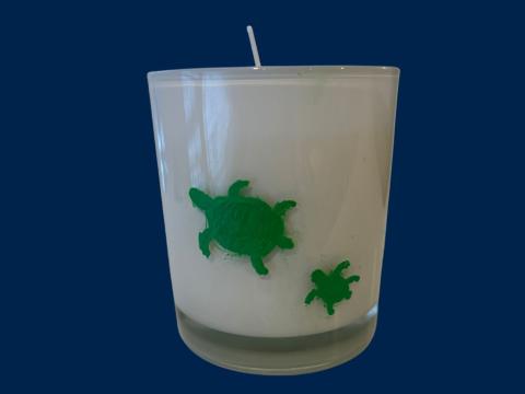 candle with two swimming turtles