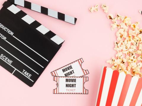 Movie clapper, tickets, and popcorn