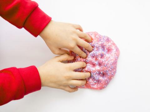 Kid playing with colorful slime