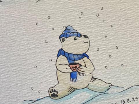 Bear sitting on a snow bank