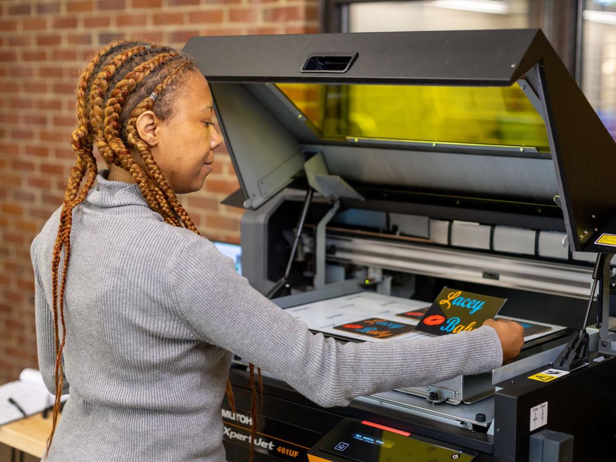 A person uses an ultraviolet printer