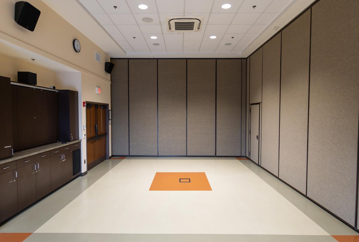 Small meeting room with cabinets on one side.